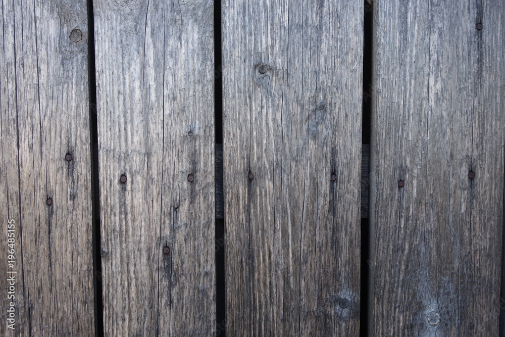 Old plank wooden wall background. The texture of old wood. Weathered piece of wood.