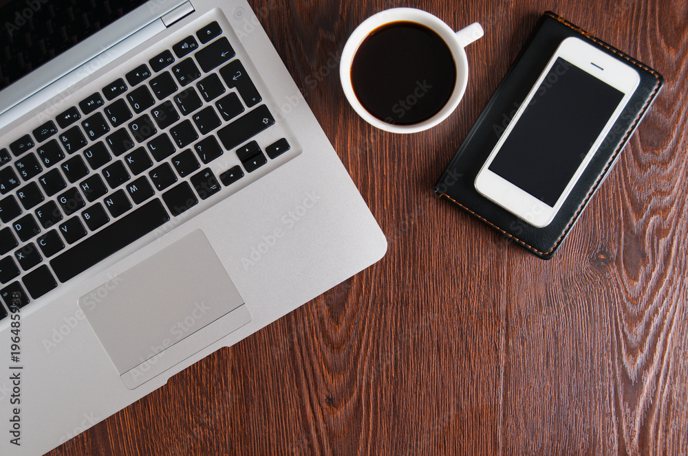 Notepad, laptop with pencil and coffee cup on wood table Notepad, laptop with pencil and coffee cup on wood table