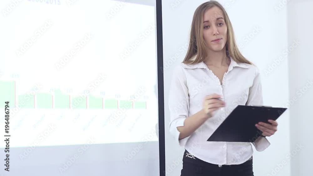Beautiful business woman is working in the office at a conference on modern technologies. Presentation to the employees of the office for the promotion of business in the sphere of services and sales. Beautiful business woman is working in the office at a conference on modern technologies. Presentation to the employees of the office for the promotion of business in the sphere of services and sales.