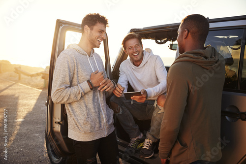 Three male friends on a road trip using a tablet computer #196486727