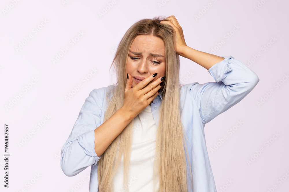 Worried female in difficult life situation, made a mistake, nervous, thinking, keeps hand on face and head. Upset woman Worried female in difficult life situation, made a mistake, nervous, thinking, keeps hand on face and head. Upset woman
