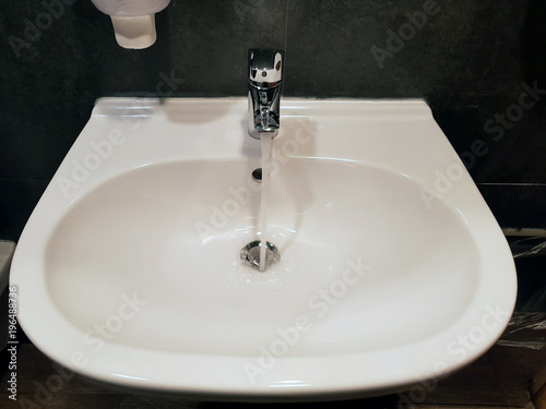 Ceramic washbasin with chromed faucet.