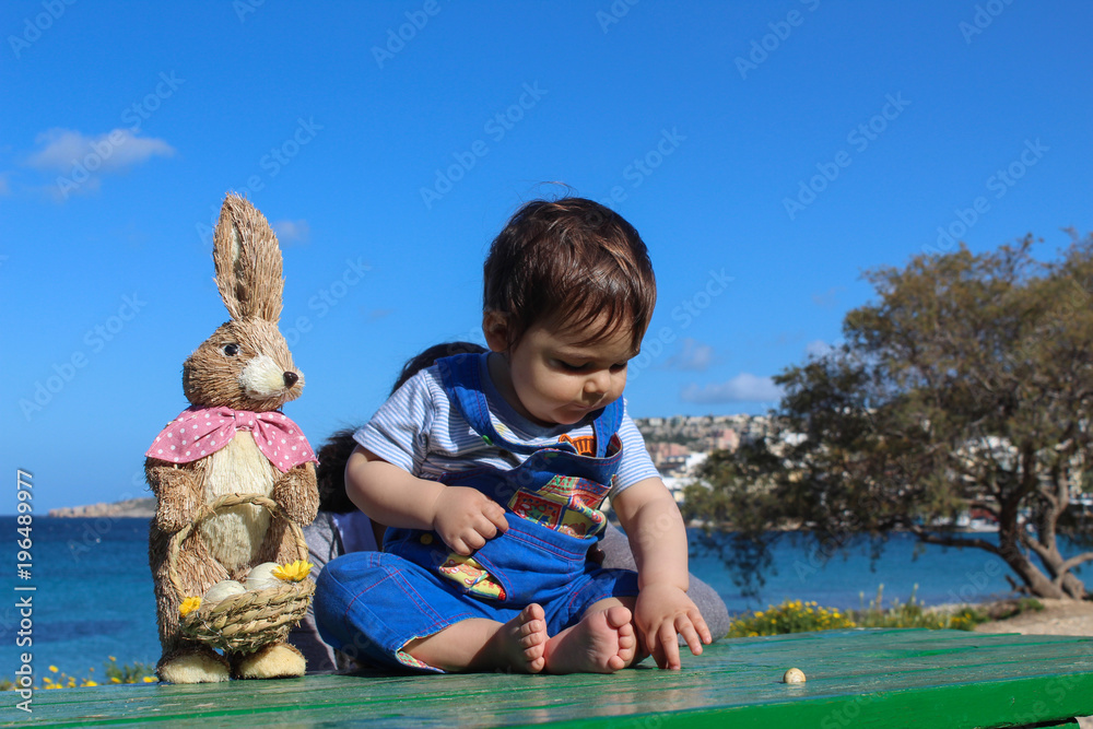 Baby boy surounded with flowers easter concept Baby boy surounded with flowers easter concept