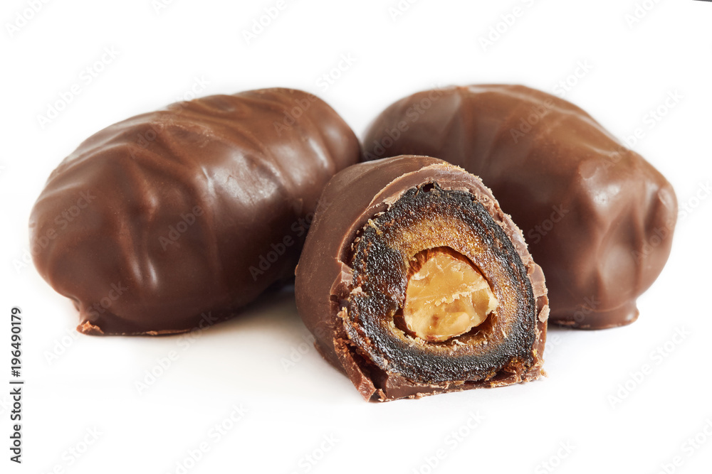 Chocolate covered dates stuffed with almonds isolated on white background Chocolate covered dates stuffed with almonds isolated on white background