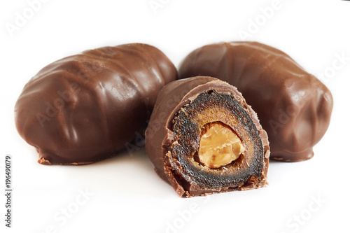 Chocolate covered dates stuffed with almonds isolated on white background