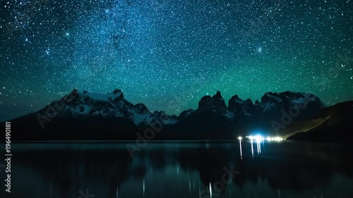 Torres del Paine National Park at night, timelapse with reflexion in the lake of Pehoe, Chile photo