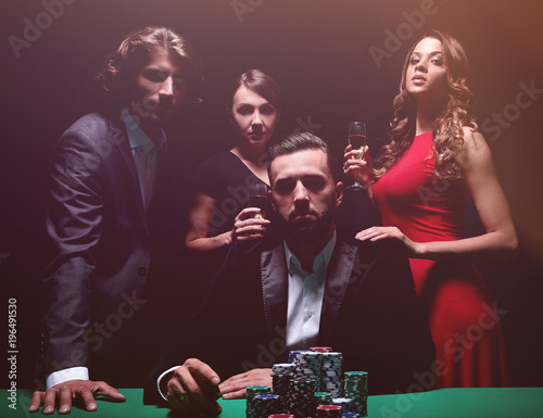 Fotografija Attractive young caucasian man make bet in the casino