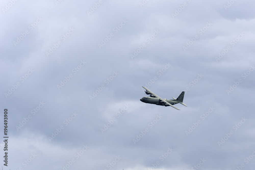 A military aircraft flying through the Scottish Highlands at speed