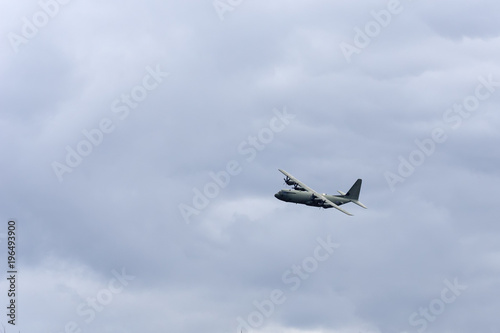 A military aircraft flying through the Scottish Highlands at speed