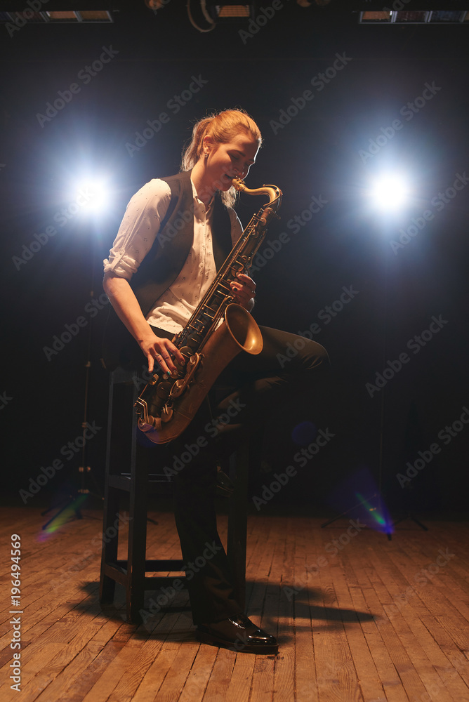 Naklejka premium The girl playing the saxophone
