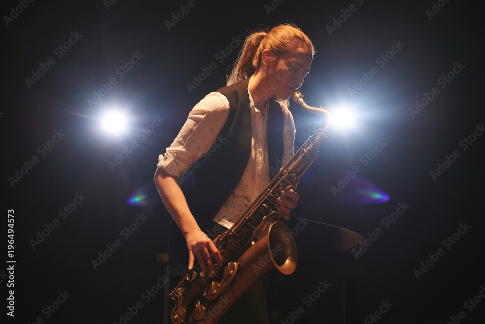 The girl playing the saxophone The girl playing the saxophone