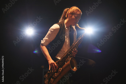 The girl playing the saxophone