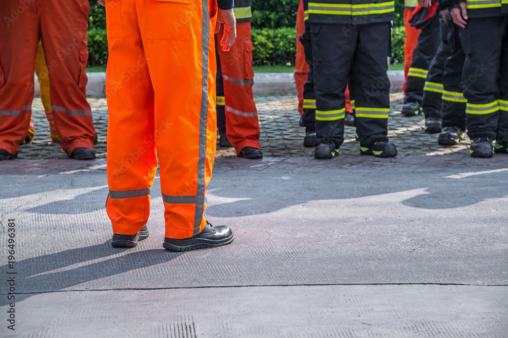 Fototapeta premium fireman standing in row with fire fighting protection suit and equipment standby for operation