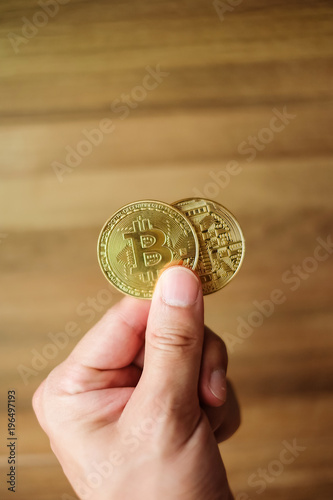 Golden Bitcoins in hand concept of digital finace can pay