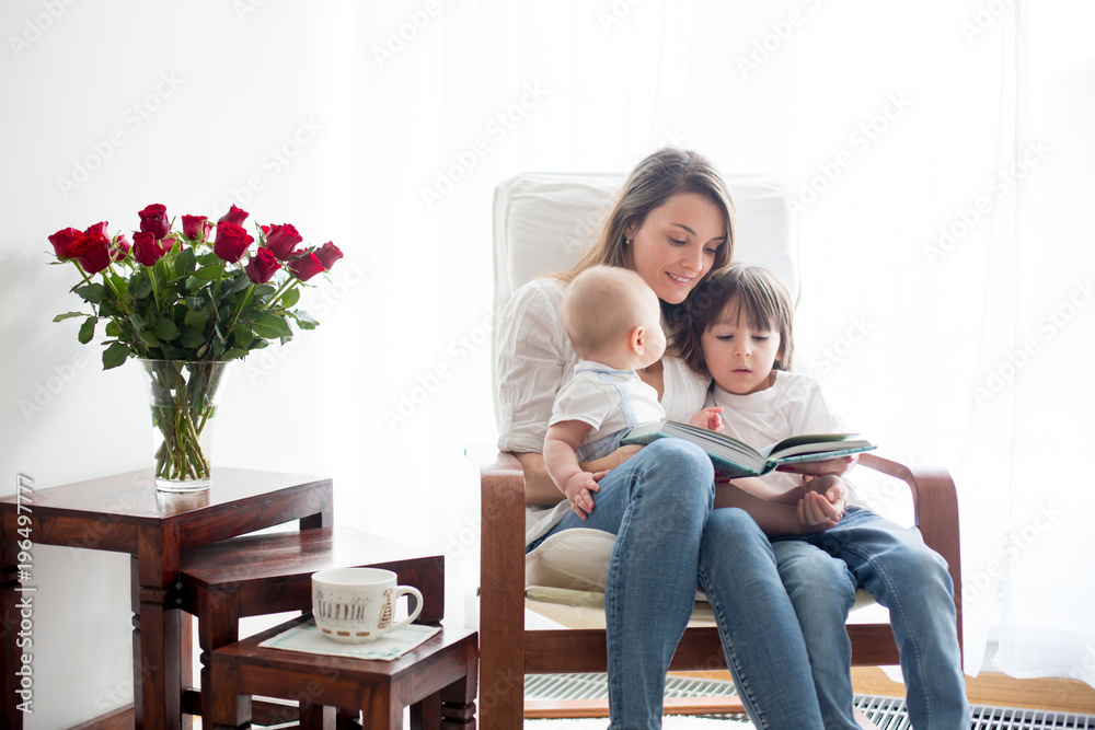 Mother, playing with her toddler boy and his older brother Mother, playing with her toddler boy and his older brother