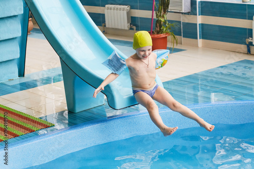 GRODNO, Belarus - Health resort Porechye. Children skiing with a water slide swimming in the pool.