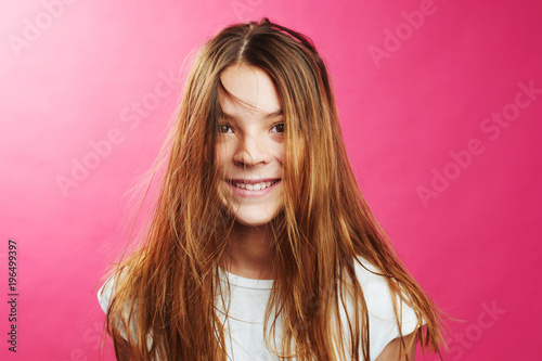 Tableau sur toile Portrait of brown-haired girl on pink background