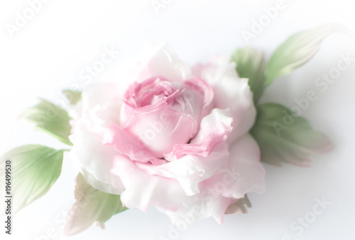 Realistic Fabric Silk flower in pink and white colors rose hand made on white background. Vintage style, retro, card, close-up