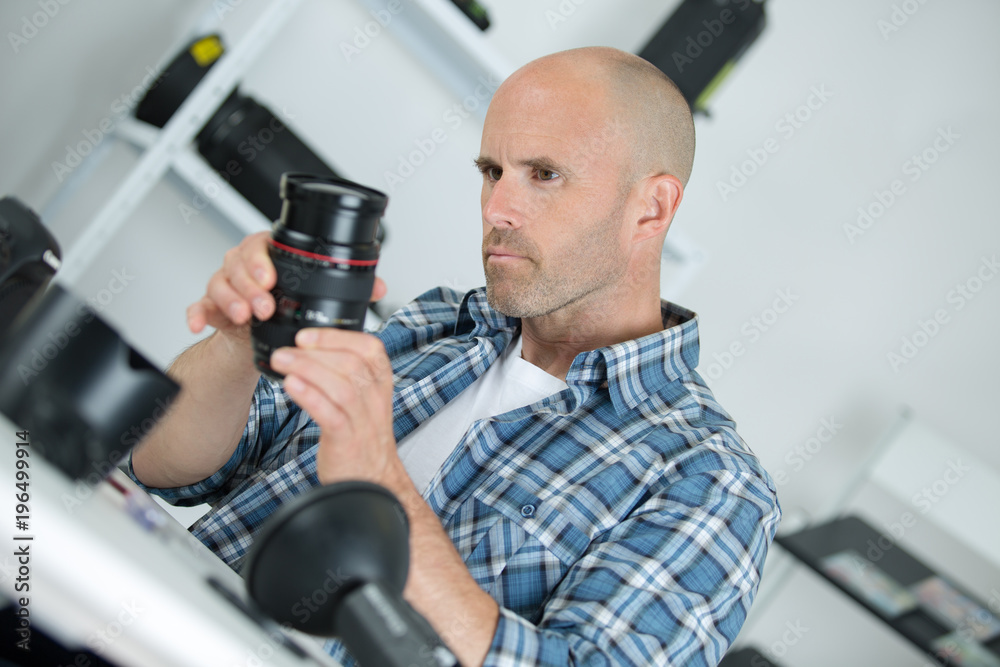 repairman holding camera lens