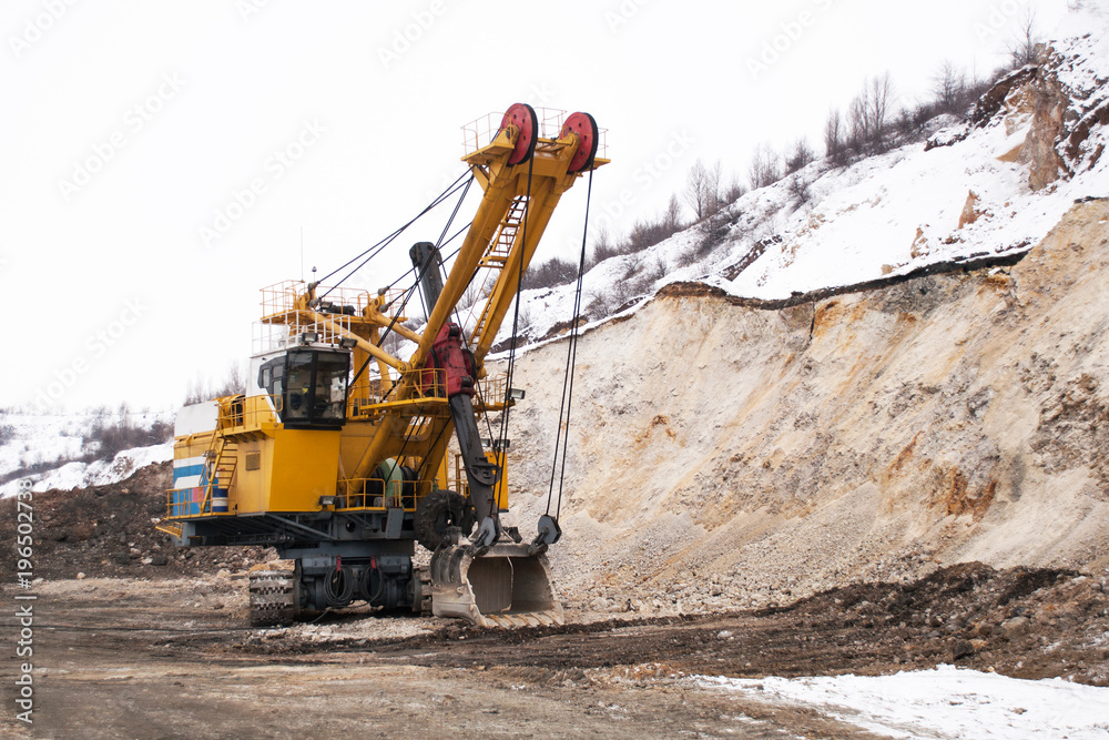 excavator in a winter ore quarry