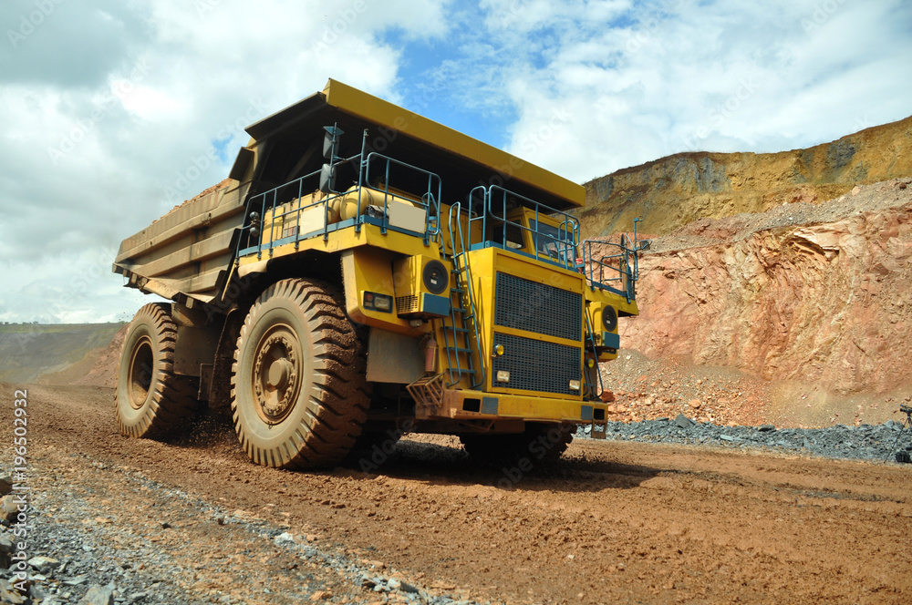 the dump truck transports iron ore. Colorful quarry.