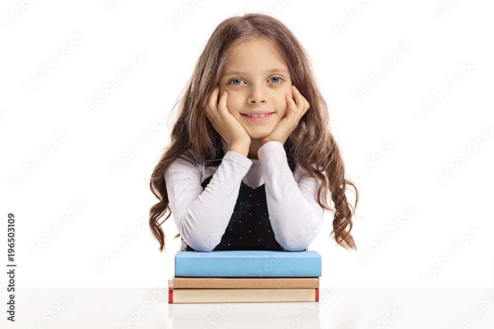 Cute little girl leaning on books and smiling Cute little girl leaning on books and smiling