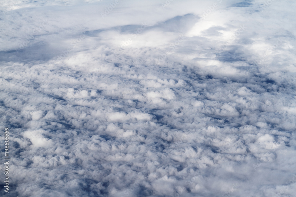 Sunrise above clouds from airplane window Sunrise above clouds from airplane window
