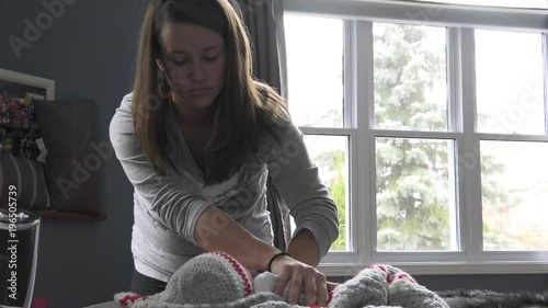 mother comforts her baby using finger as soother photo