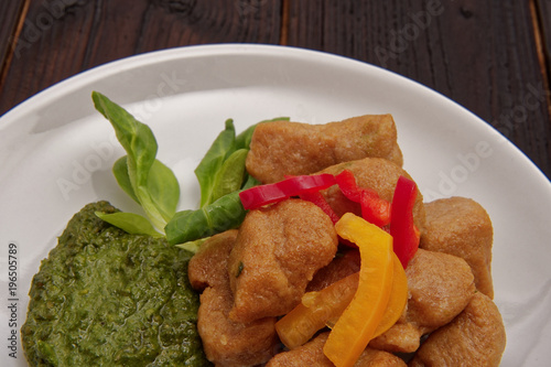 Batato gnocchi with pesto on a table photo