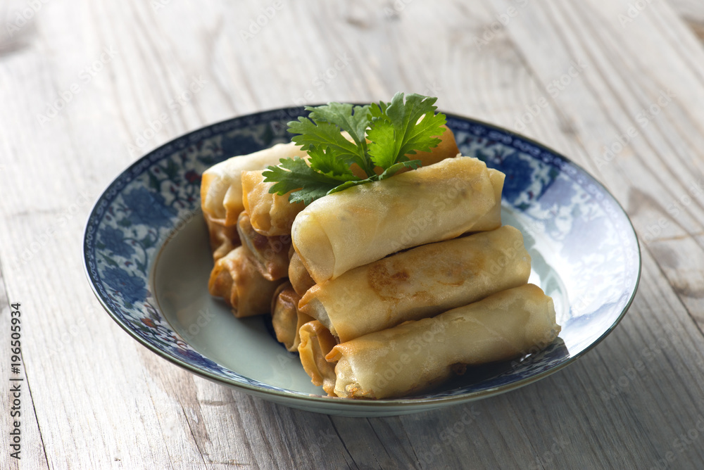 Lumpia Spring Rolls on Wooden Table in Restaurant Lumpia Spring Rolls on Wooden Table in Restaurant