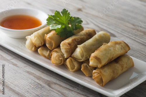 Lumpia Spring Rolls on Wooden Table in Restaurant photo