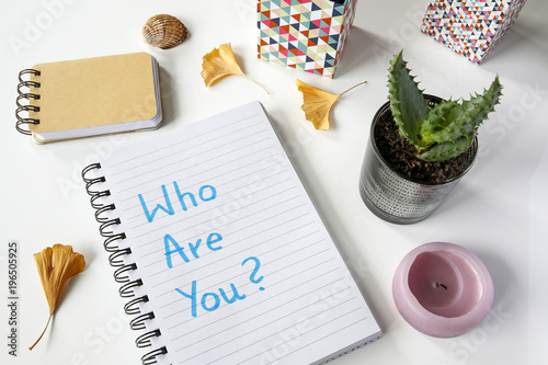 Who Are You? written in notebook on white table