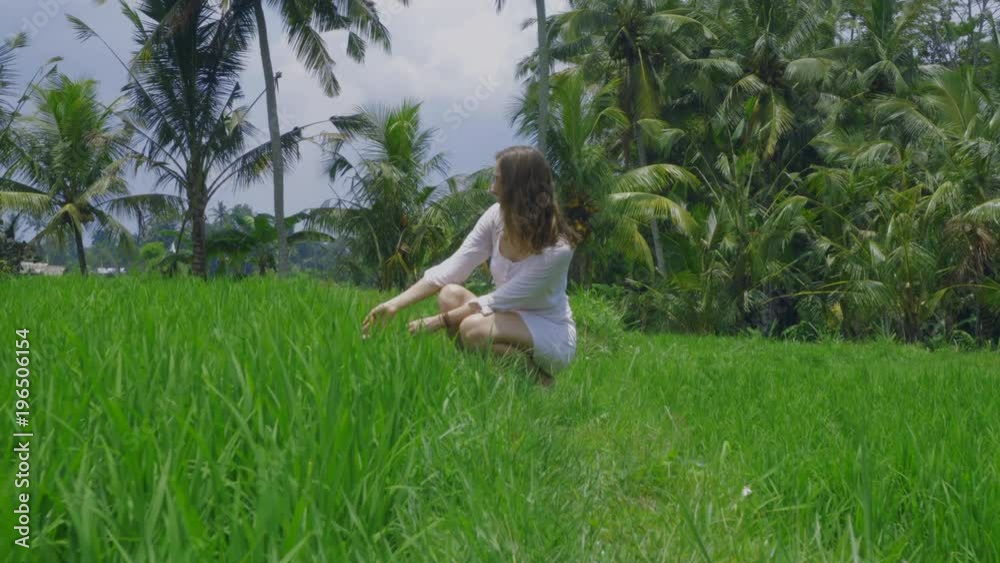 custom made wallpaper toronto digitalBeautiful slender young female model in a light tunic is sitting posing on the rice field with palm trees on Bali, shooting 4K with camera stabilizer, wonderful view