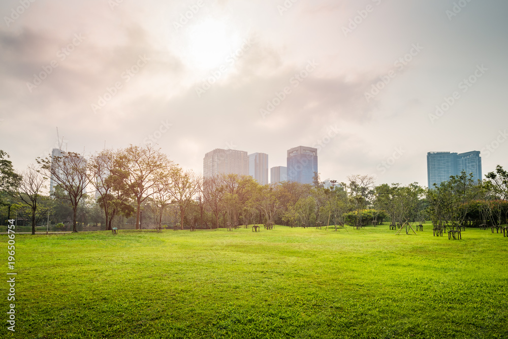Green grass field with building in Public Park Green grass field with building in Public Park