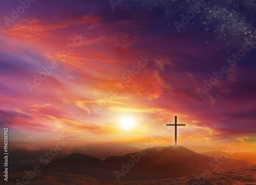 The Light of Christ Crucifix . Light of God . Light from sky . Cross on the top of the hill . Dramatic nature background . Sunset or sunrise with clouds, light rays and other atmospheric effect .