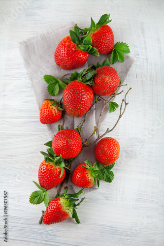fresh ripe strawberries on shabby chic white wood plate kitchen table can be used as background