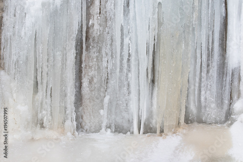 Frozen waterfall background. Wall texture from big icicles