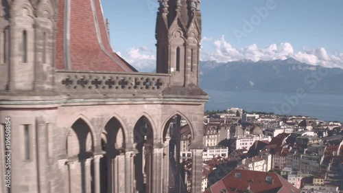 Lausanne Cathedral cinematic drone shot. Camera flying over the city and revealing the beautiful cathedral