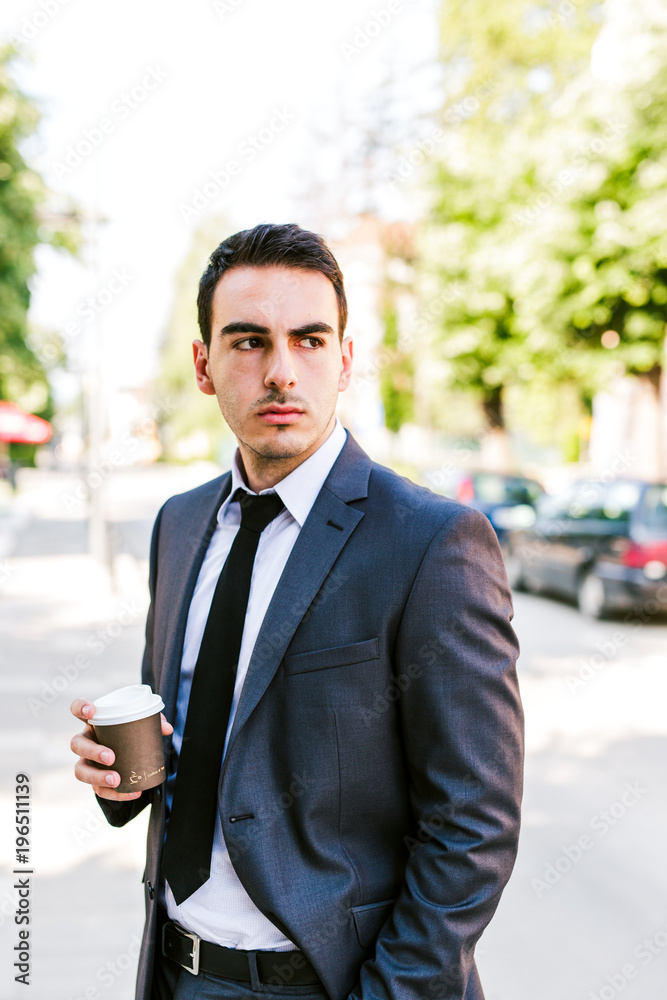 Young businessman take break to drink coffee outdoor Young businessman take break to drink coffee outdoor