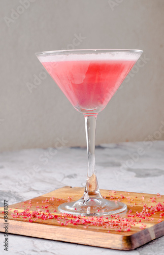 Top view red pink cocktail Margarita fresh in a martini glass on a wooden board, gray background. Bar alcohol drink menu, delicious tequila sunrise long drink.