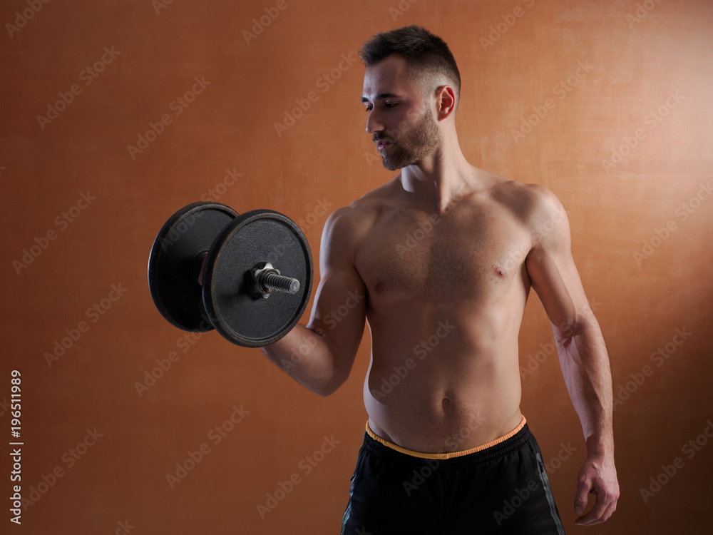 Young man training with weight lifting.