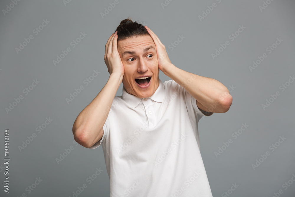 Shocked young man standing isolated Shocked young man standing isolated