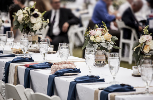 Canvas Print Table set up for wedding reception with people out of focus in background