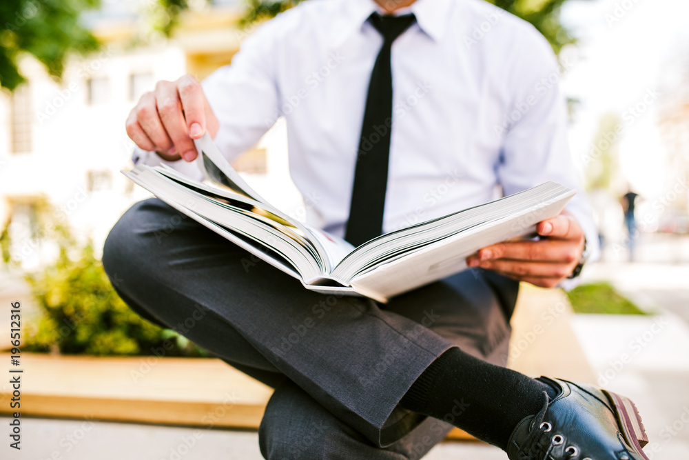 Fototapeta premium Young Businesswoman Flipping Through Photo Book