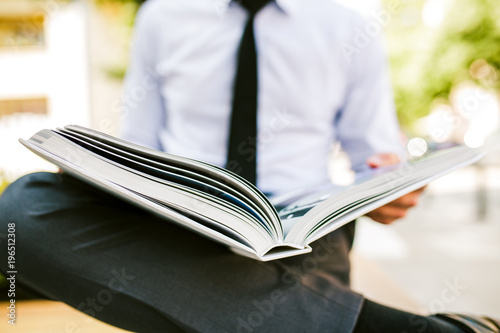 Young Businesswoman Flipping Through Photo Book