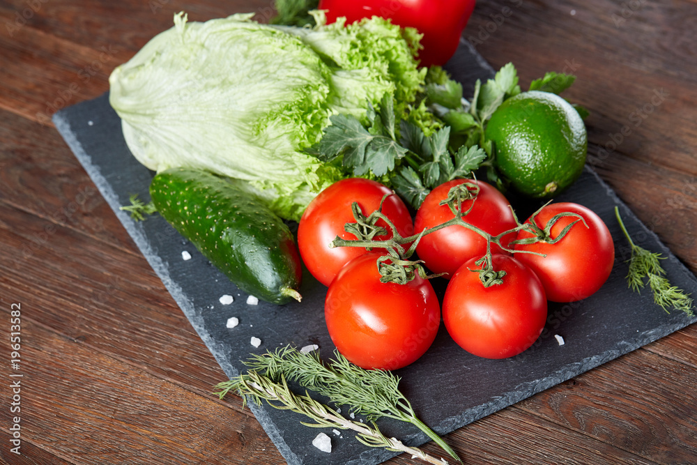 Vegetarian still life of assorted fresh vegetables and herbs on vintage wooden background, top view, selective focus. Vegetarian still life of assorted fresh vegetables and herbs on vintage wooden background, top view, selective focus.
