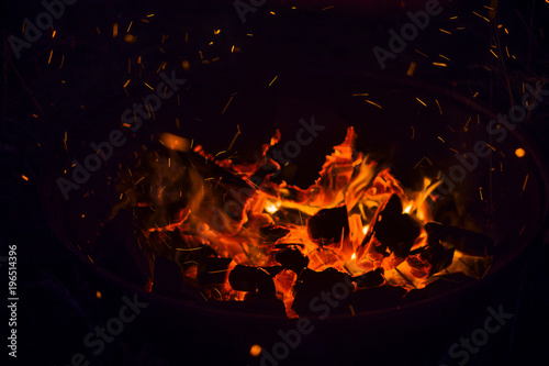 Fire burning in a barbecue, in a hike outside the city in the forest