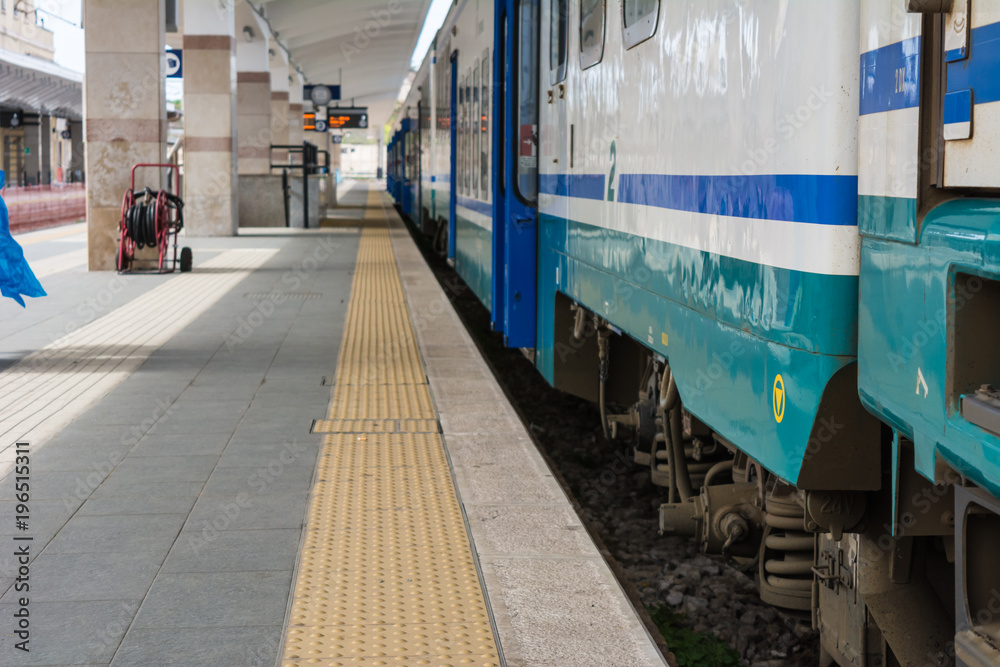 Naklejka premium Horizontal View of a Train Stopped in a Railway Station on Blur Background