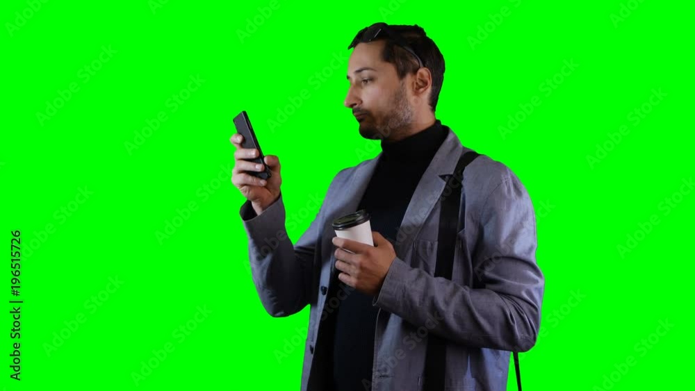 Man in suit and black sunglasses use mobile and hold coffee cup. Green screen, footage. Man in suit and black sunglasses use mobile and hold coffee cup. Green screen, footage.