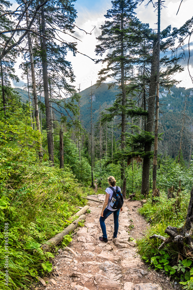 Woman hiker on mountain trail